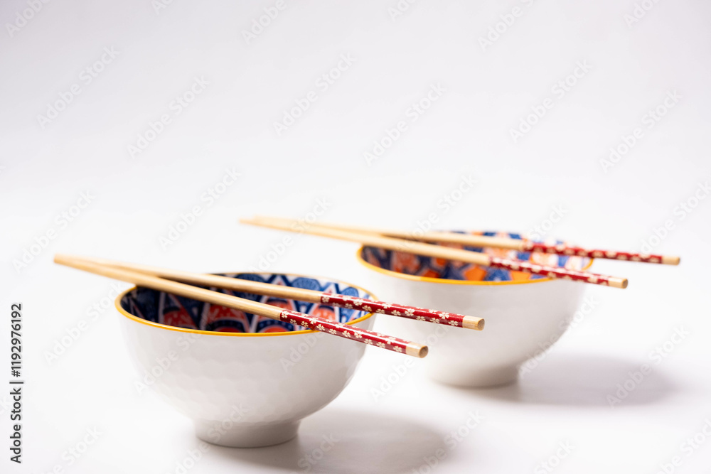 patterned bowl with chopsticks and white background
patterned bowl with chopsticks and white background