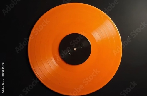 Bright orange vinyl record with a black center label on a sleek black background, showcasing vibrant retro audio aesthetics