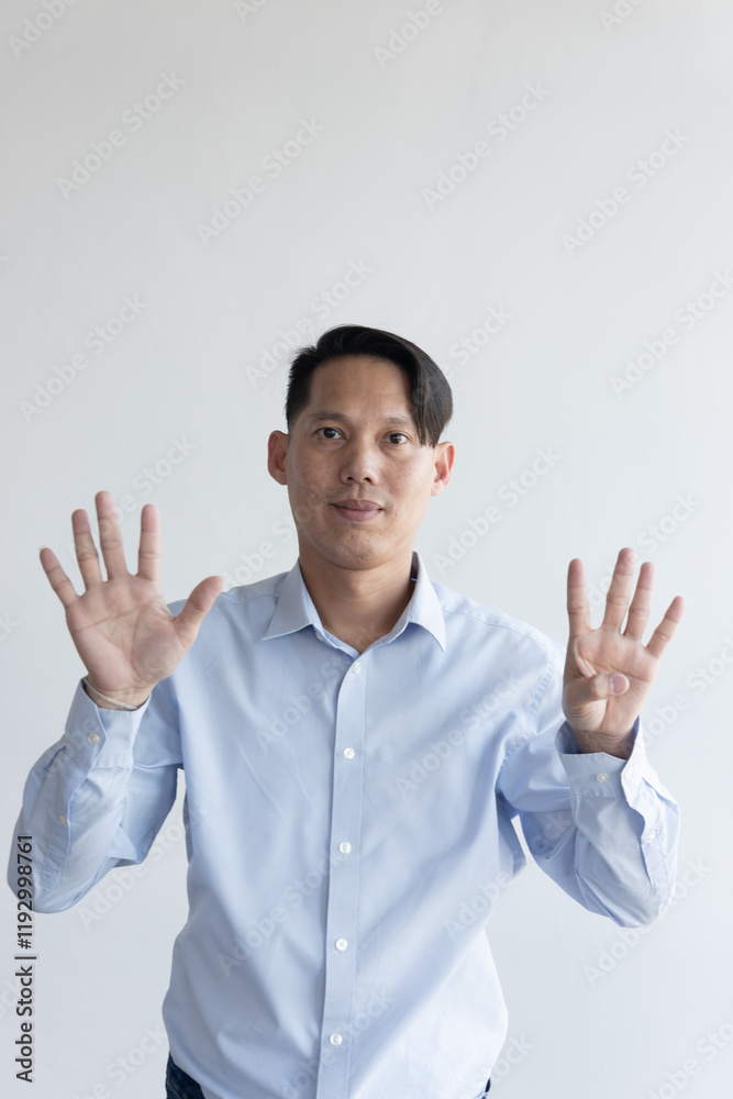 Healthy happy smiling middle aged southeast asian man pointing 9 fingers up, concept of nine points, number nine, 9th place on isolated background Healthy happy smiling middle aged southeast asian man pointing 9 fingers up, concept of nine points, number nine, 9th place on isolated background