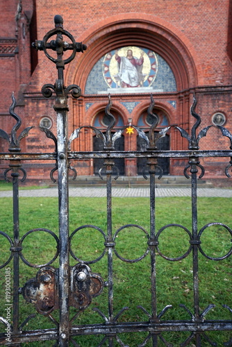 Fassade aus Klinker in Rot der evangelischen Immanuelkirche im neoromanisch Stil mit Tor aus Schmiedeeisen an der Prenzlauer Allee am Prenzlberg oder Prenzlauer Berg in der Hauptstadt Berlin photo