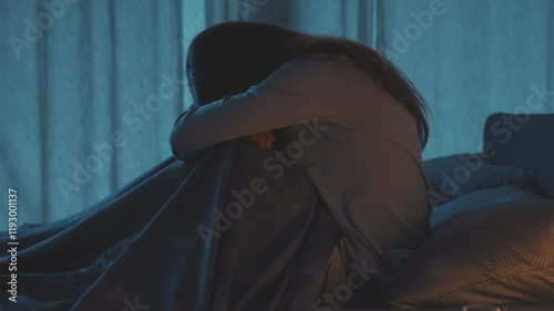 Unhappy woman in bed at night