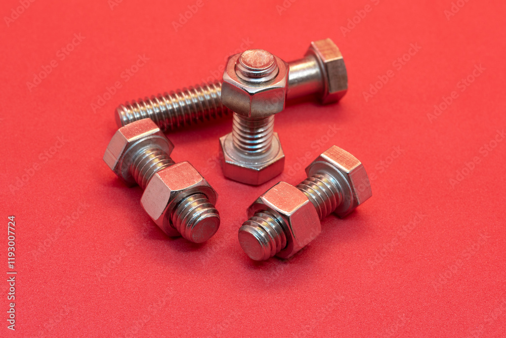 Bolts and nuts on a red background Bolts and nuts on a red background