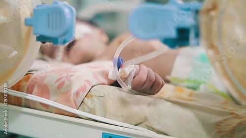 Closeup lovely little newborn baby infant lying in incubators for newborns, Newborn baby having the the breathing problem after birth, newborn in NICU, Neonatal intensive care unit.