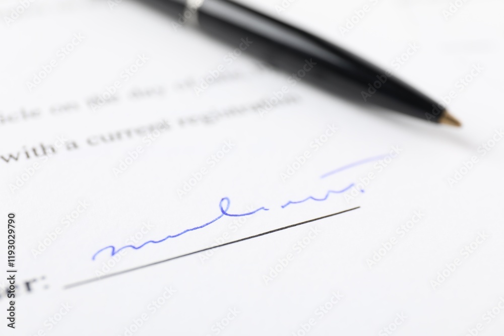 Signature and pen on paperwork, closeup view Signature and pen on paperwork, closeup view