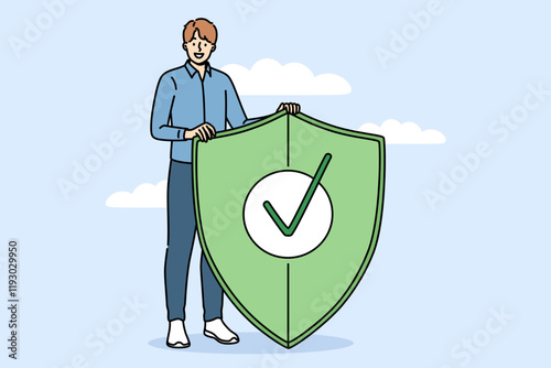 Cyber ​​protection used by business man holding green shield, symbolizing fight against digital viruses. System administrator recommends installing firewall reminds us of importance cyber protection