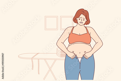 Woman experiencing problems with excess weight tries to put on small pants, and needs diet. Girl with excess weight does not fit into clothes due to appearance of belly and cellulite caused by obesity