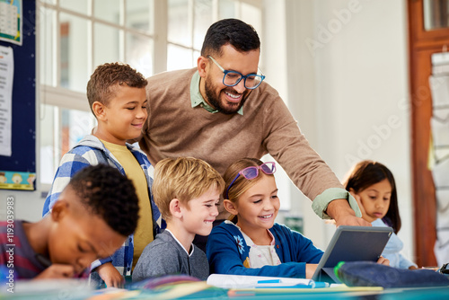 Primary multiethnic pupils working on digital tablet with teacher photo