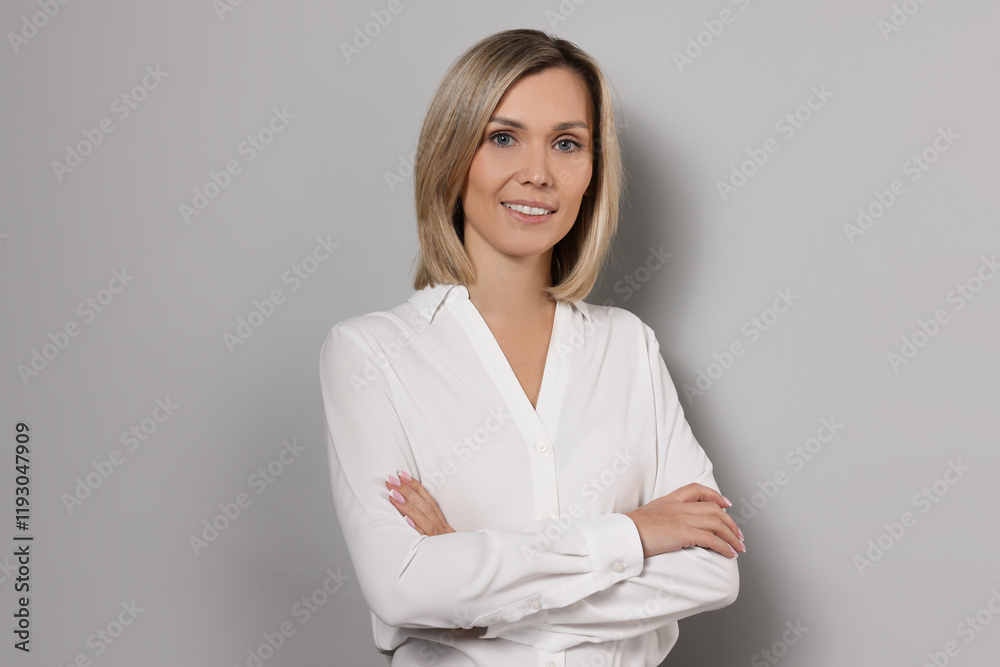 Portrait of businesswoman in white shirt on gray background Portrait of businesswoman in white shirt on gray background