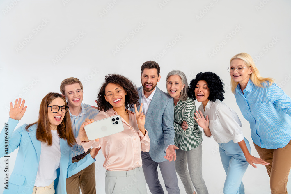 Group of diverse professionals taking a cheerful selfie together in formal and casual wear Group of diverse professionals taking a cheerful selfie together in formal and casual wear