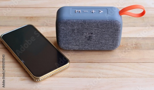 Gray bluetooth speaker and smartphone
