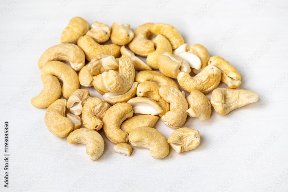 Fototapeta premium Cashew nuts, known as Kaju Badam in Bengali, are isolated on a white background.