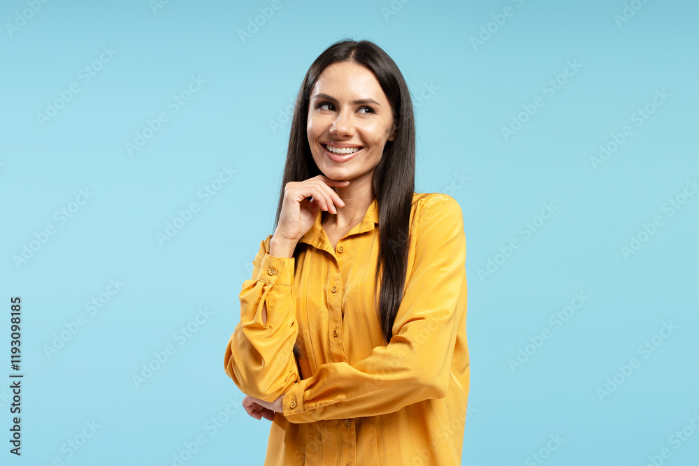 Smiling businesswoman thinking and looking away on blue background Smiling businesswoman thinking and looking away on blue background
