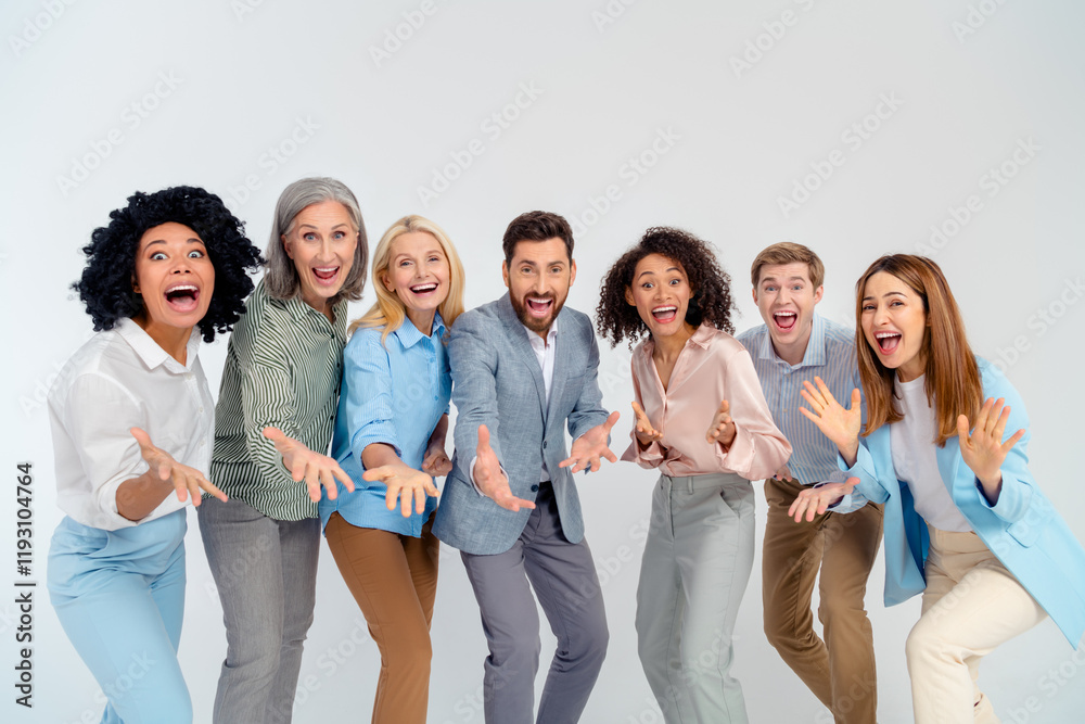 Diverse smiling professionals in formalwear joyfully pose together in bright atmosphere on grey background Diverse smiling professionals in formalwear joyfully pose together in bright atmosphere on grey background