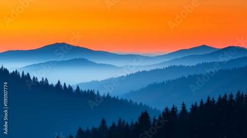 Vibrant sunset over layered blue mountains and dark forest.