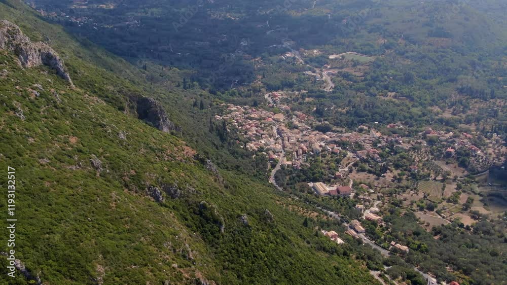 Aerial view of a mountainous landscape with a small village in background, Corfu,Greece Aerial view of a mountainous landscape with a small village in background, Corfu,Greece