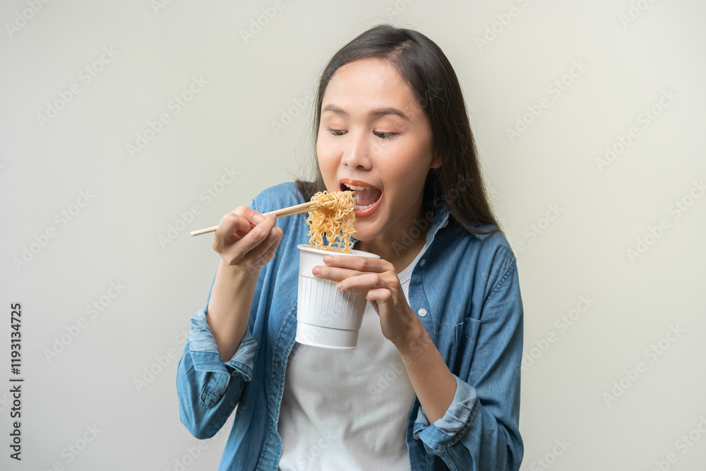 Happy temptation, attractive asian young student woman, cute girl using chopsticks eating instant ramen, noodles soup from a cup, cooking meal fast food lifestyle of traditional japanese person. Happy temptation, attractive asian young student woman, cute girl using chopsticks eating instant ramen, noodles soup from a cup, cooking meal fast food lifestyle of traditional japanese person.