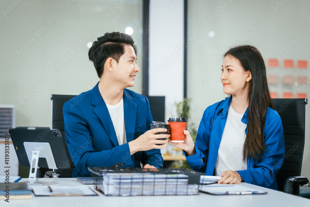 A businessman and businesswoman are working together at a desk, using a laptop.They are discussing business strategies,financial planning, collaboration to achieve their corporate goals effectively A businessman and businesswoman are working together at a desk, using a laptop.They are discussing business strategies,financial planning, collaboration to achieve their corporate goals effectively