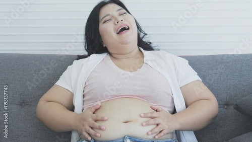chubby woman holding her belly 