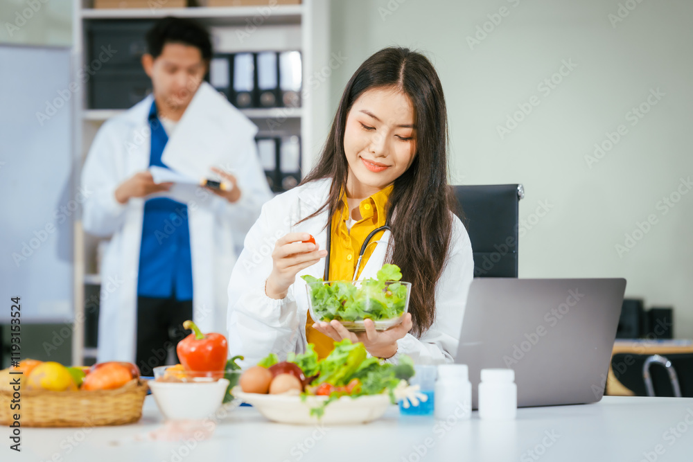 Two nutritionists,female and male, work in a hospital, analyzing vegetable and fruit salads, offering online advice, helping patients embrace clean eating habits and weight control for better health Two nutritionists,female and male, work in a hospital, analyzing vegetable and fruit salads, offering online advice, helping patients embrace clean eating habits and weight control for better health