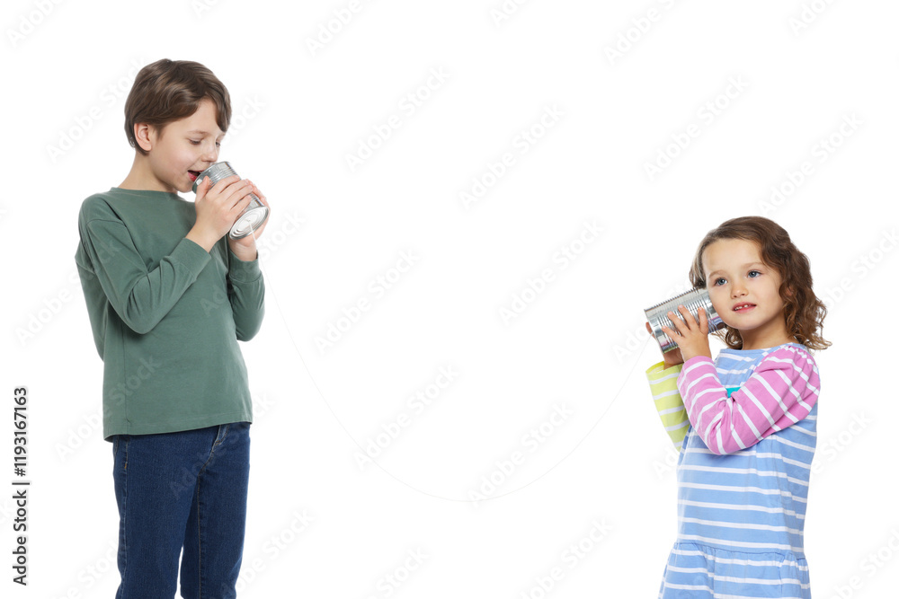 Boy and girl talking on tin can telephone against white background Boy and girl talking on tin can telephone against white background