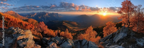 Stunning autumn panorama of vibrant foliage against majestic mountain landscape at sunset with golden light illuminating the scenery