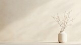 Minimalist beige wall background with dried flowers in a ceramic vase.