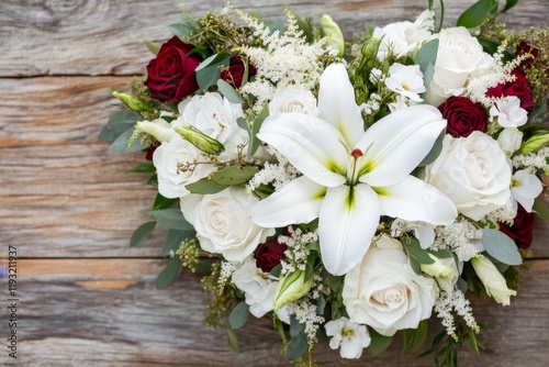A stunning floral arrangement in the shape of a heart, featuring roses, lilies, and delicate baby's breath