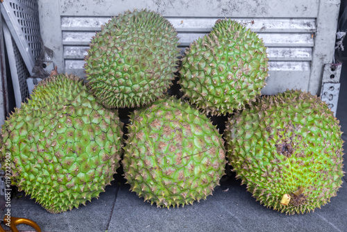Raw durian fruits for sale at rural market in Bangkok, Thailand.