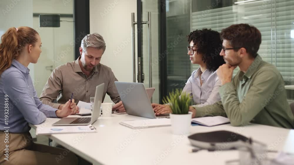 Business people working together on a project using laptop in office meeting room Business people working together on a project using laptop in office meeting room