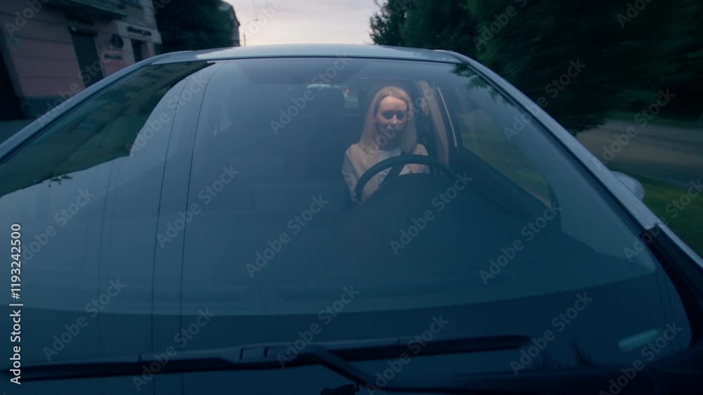 Caucasian businesswoman female girl business woman taxi driver automobile transport owner inside automobile vehicle driven automatically steering wheel seat belt driving ride city town street evening
