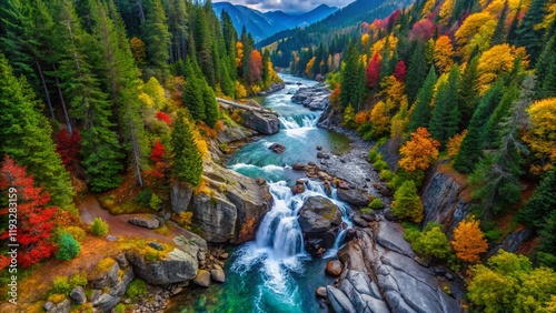 Aerial View of Mountain Stream and Waterfall cascading through lush forest