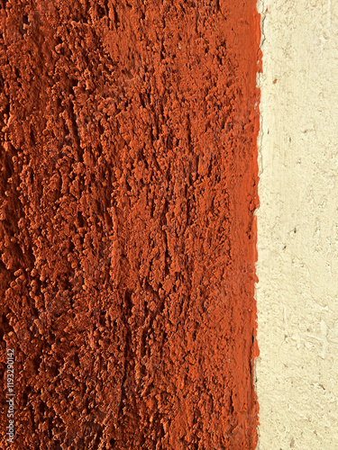 The texture of terracotta plaster on the wall in close-up