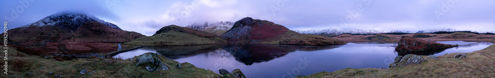 Fototapeta premium Panorama view of Llyn y Dywarchen with mountains of Y Garn, Bryn Gwyn, Clogwyngarreg and Snowdonia mountain range
