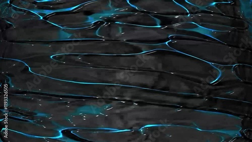 A close-up of a dark, glossy surface with wavy textures and glowing blue reflections. The abstract pattern creates a futuristic and mysterious atmosphere, resembling liquid metal or synthetic material