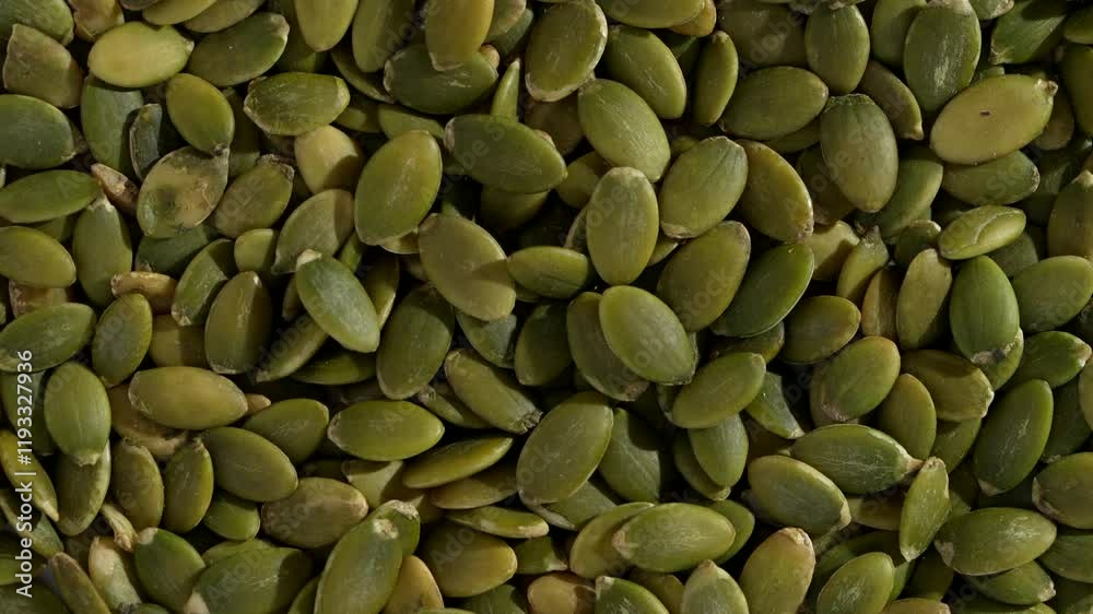 Macro video of pumpkin seeds on rotating disc. Close up of bunch of pumpkin seeds.