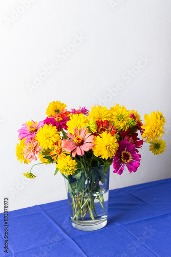 A summer bouquet featuring colorful Zinnia and Rudbeckia Goldquelle flowers adds vibrant beauty to home decoration, perfect for a seasonal and cheerful floral arrangement photo