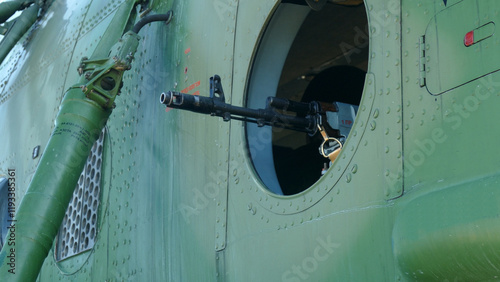 machine gun mounted in the window of a military helicopter