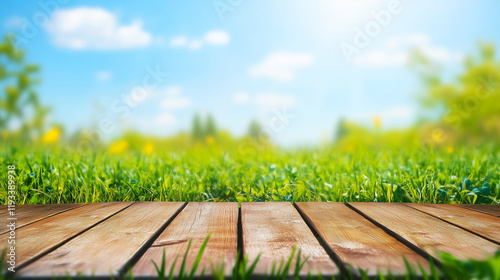 wooden deck with a vibrant green grass field and sunny blurred background ideal for nature-themed promotions and outdoor product displays