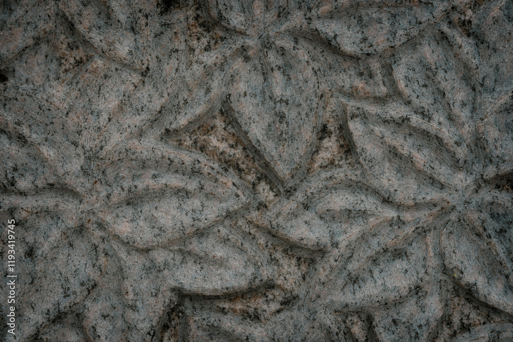 Naklejka premium engraved tree leaves in granite. Carving texture background.