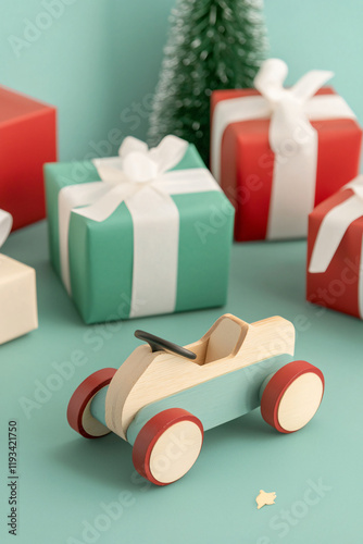 vintage wooden toy car surrounded by wrapped gifts, azure backdrop photo