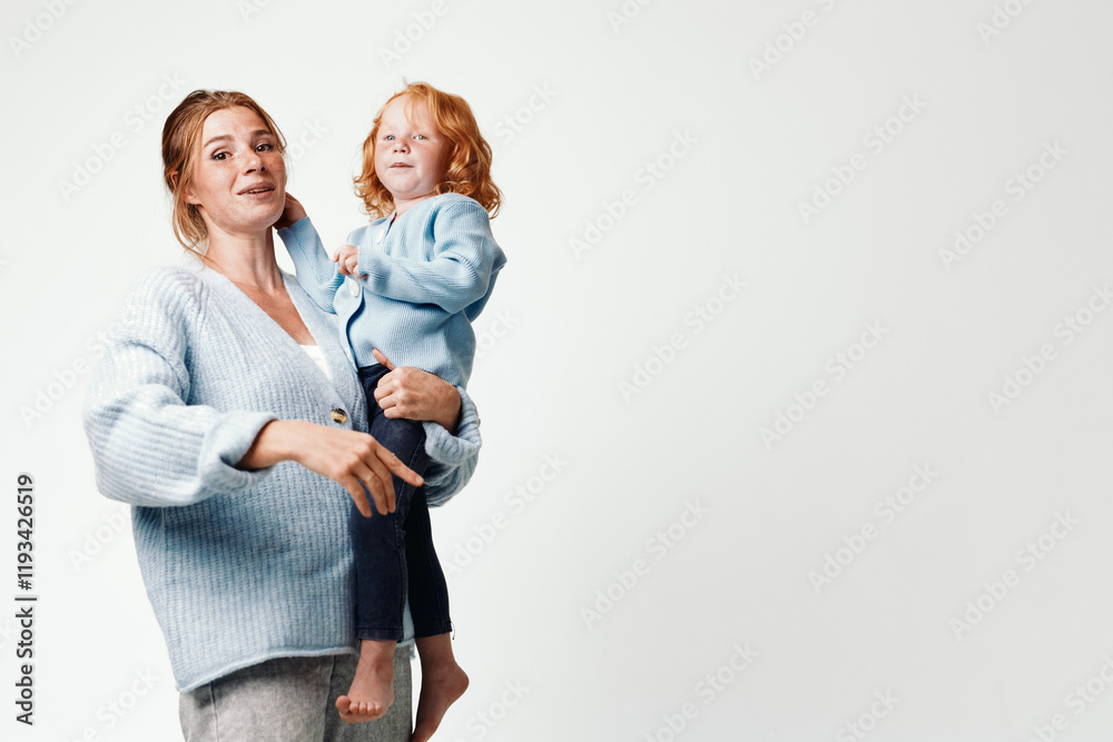 Mother and daughter joyfully playing in the air on a white background Mother and daughter joyfully playing in the air on a white background