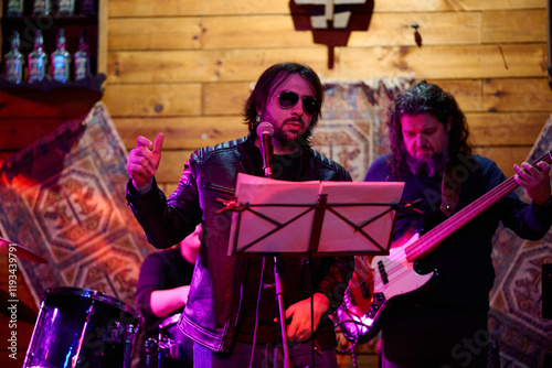Live performance by a heavy metal band at a vibrant concert venue in the evening