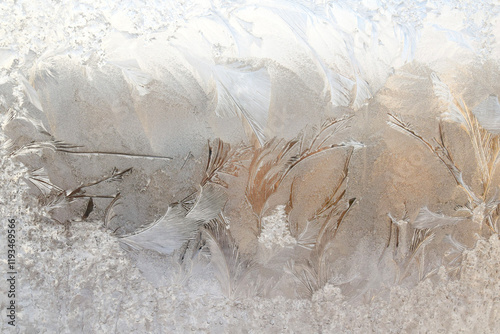 Magic background. Ice patterns on winter glass photo