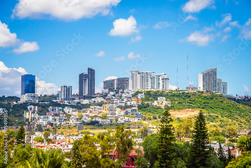 ´Urban landscape seen from the viewpoint of the arches, with buildings in the background and a blue sky with white clouds, in queretaro photo