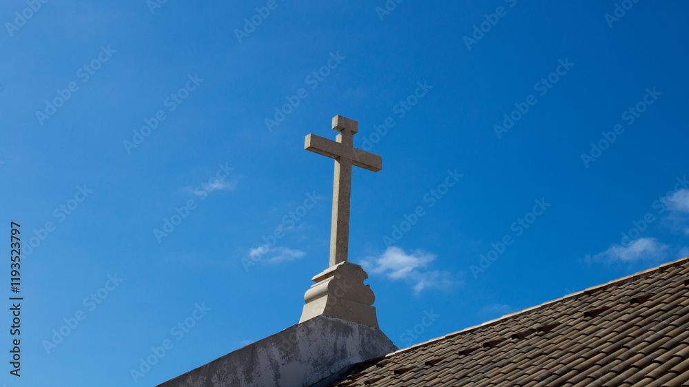 View of the church cross against blue sky. Close-up. Funchal. Madeira. Portugal. View of the church cross against blue sky. Close-up. Funchal. Madeira. Portugal.