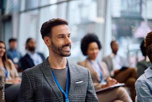 Happy entrepreneur attending business seminar in conference hall. photo