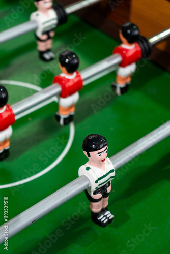 Foosball table with players representing Sport Lisboa e Benfica and Sporting Clube de Portugal, highlighting a friendly football rivalry in a playful setting. photo