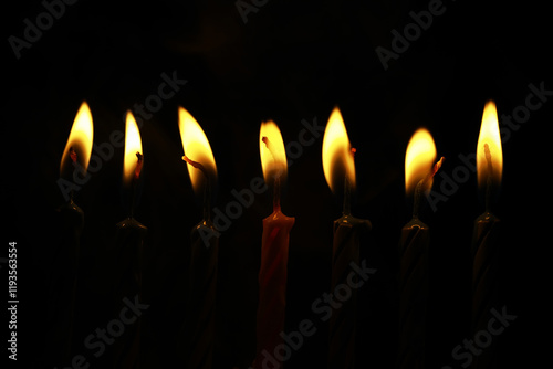 Seven Lit Candles in Dark Background: Celebratory, Warm, Spiritual, Mystical Ambience Image
