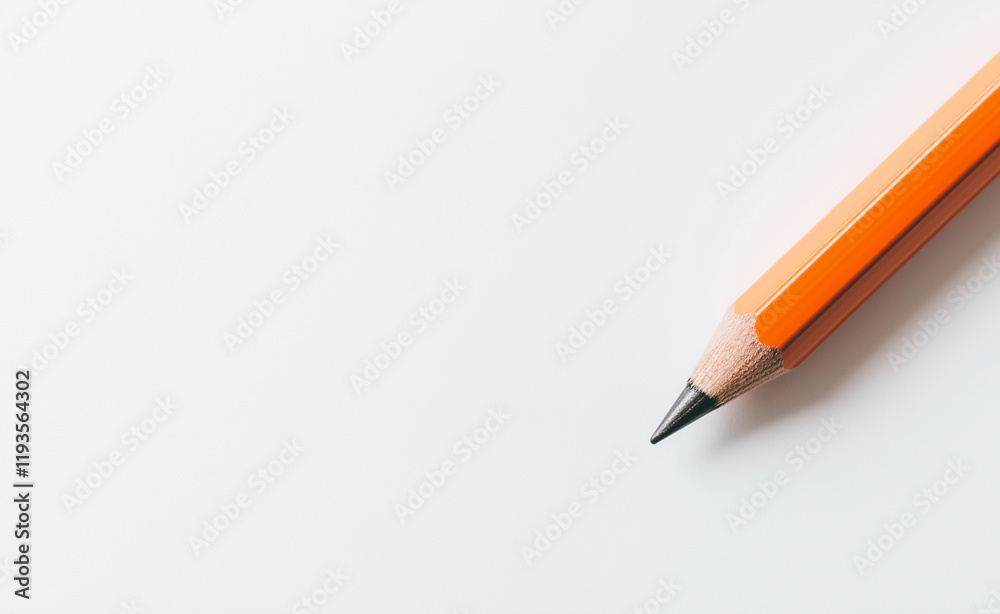 A sharpened orange pencil placed on a clean white background, symbolizing creativity and simplicity. A sharpened orange pencil placed on a clean white background, symbolizing creativity and simplicity.