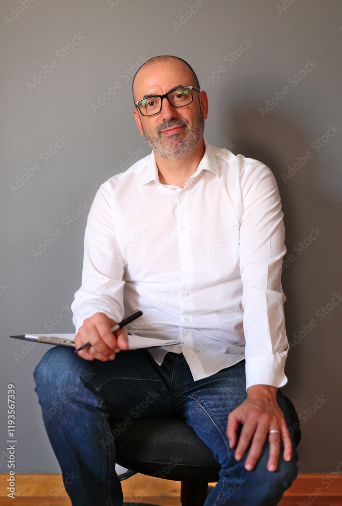 Fototapeta premium Confident Professional Sitting with Documents in a Comfortable Modern Setting